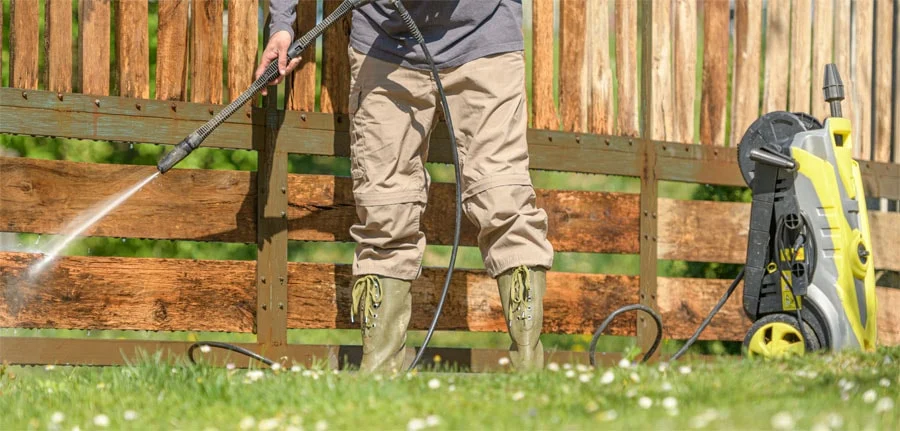 Man cleans a fence.