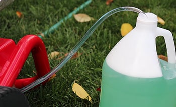 Canister of the detergent connected to the pressure washer by the tube